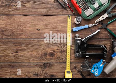 Tools Are Arranged on a Wooden Surface With a Tape Measure and Various Hand Tools Visible Stock Photo