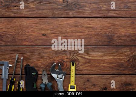 Tools Arranged on Wooden Surface for Repair Work in a Workshop Setting Stock Photo