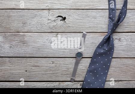 Watch and Tie Arranged on Wooden Surface During Daytime for Fashion Display Stock Photo