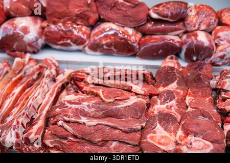 Cuts of raw beef in display case of butchery shop Stock Photo