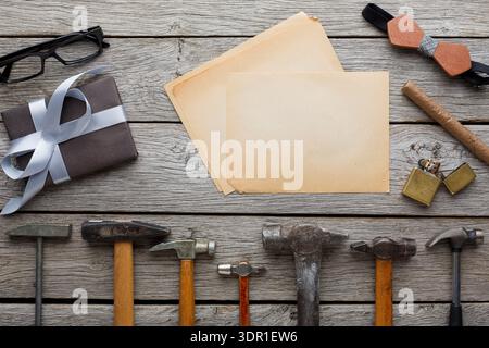 Explore Various Hand Tools and Office Supplies Arranged on a Wooden Table Stock Photo