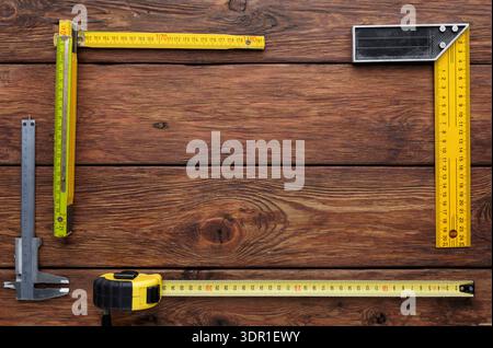 Tools for Measuring and Layout on Wooden Surface During Construction Process Stock Photo