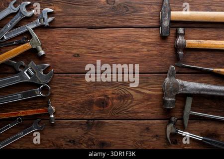 Various Hand Tools Arranged on a Wooden Surface for Repair and Maintenance Work Stock Photo