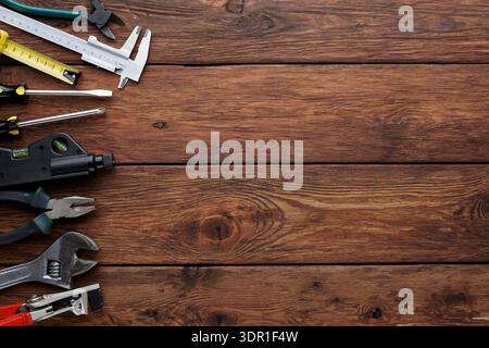 Various Tools Arranged on Wooden Surface for Repair and Construction Tasks Stock Photo