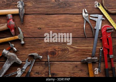 Work Tools Arranged on Wooden Surface for Maintenance and Repair Activities Stock Photo