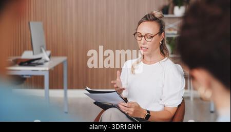 Team, woman and meeting with document in office for manuscript revision, article tips and feedback. Journalists, female editor and reading notes for Stock Photo