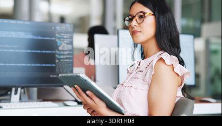 Thinking, woman and tablet for programming in office with research, planning and coding. Female person, tech and ideas for troubleshooting, website Stock Photo