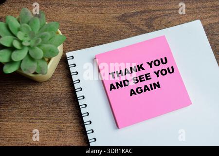 Concept of thank you and see you again write on sticky notes isolated on Wooden Table. Stock Photo