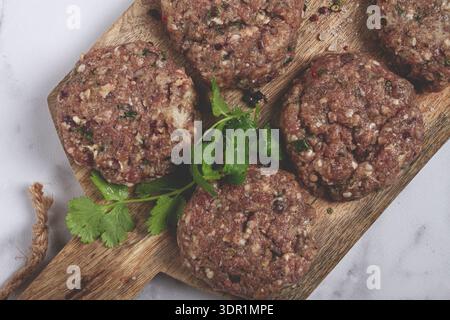 Raw cutlets, minced meat, on a chopping board, homemade, top view, no people Stock Photo