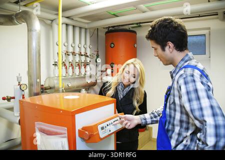 A heating technician servicing a heating system, service work, Vienna, Austria Stock Photo