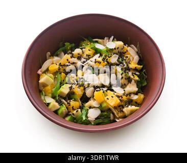 Fresh Fruit Salad With Nuts and Seeds Served in a Brown Bowl on a White Background Stock Photo