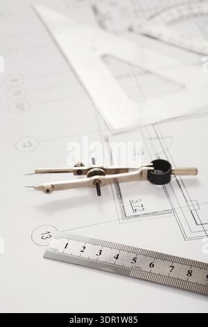 Creating a Technical Drawing With Tools and Plans on a Workspace Table During the Daytime Stock Photo