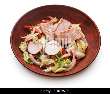 Fresh Salad With Sliced Fish and Various Vegetables Served in a Brown Bowl on a Plain Surface Stock Photo