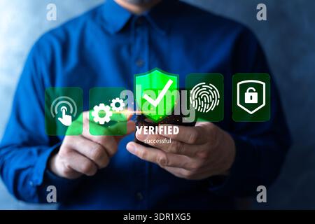 User confirming verified access on smartphone with shield checkmark, fingerprint and lock icons. Concept of cybersecurity, identity authentication, MF Stock Photo
