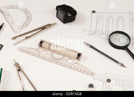 Collection of Drafting Tools and Sketches Arranged in a Mosaic on a Work Surface Stock Photo
