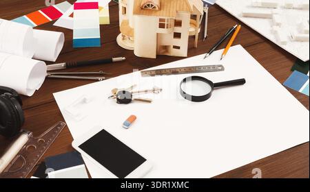 Collage of Architectural Tools, Materials, and Designs on a Wooden Table in a Workspace Stock Photo