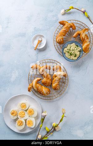 Easter brunch with bread bunny bun, egg spread and hard boiled eggs Stock Photo