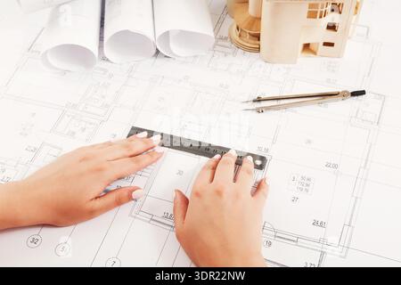 Designing a Building With Blueprints and Tools Laying on the Table Stock Photo