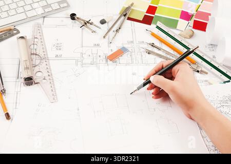 Drawing Plans on a Desk With Tools and Sketches for a Project in an Office Setting Stock Photo