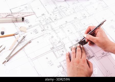 Hands Creating a Design on a Blueprint With Tools and Equipment at an Office Setting During Daytime Stock Photo