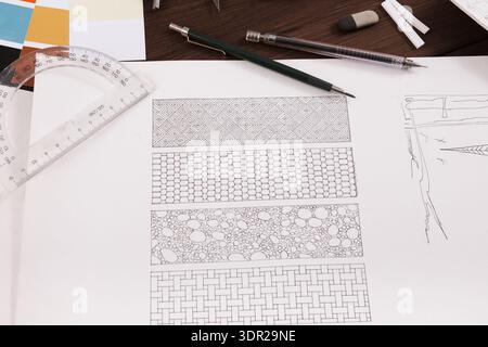 Collage of Pattern Designs Showing Detailed Sketches and Tools on a Workspace Table Stock Photo