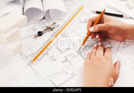 Planning a Building Project With Sketches and Design Tools on a Workspace Stock Photo