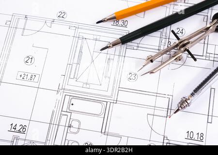 Collection of Drafting Tools and Architectural Plans on a Table for Building Design Stock Photo