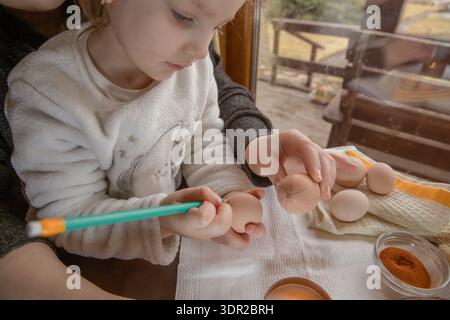 Wax decoration process of Easter eggs with natural spices and traditional pysanka technique at home Stock Photo