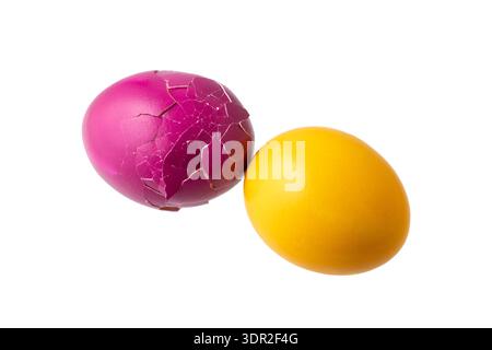 Cracked and whole painted natural chicken easter eggs isolated on white background.  Colorful easter eggs flying. Stock Photo