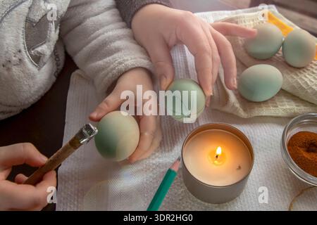 Wax decoration process of Easter eggs using traditional pysanka technique with natural spice dye at home Stock Photo