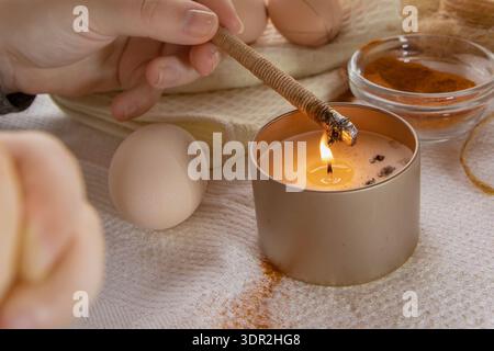 Wax decoration process of Easter eggs using traditional pysanka technique with natural spice dye at home Stock Photo