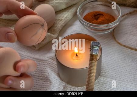 Wax decoration process of Easter eggs using traditional pysanka technique with natural spice dye at home Stock Photo