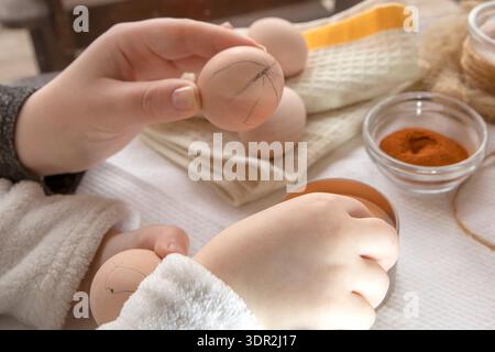 Wax decoration process of Easter eggs using traditional pysanka technique with natural spice dye at home Stock Photo