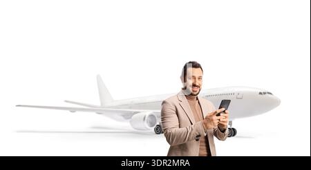 Man at the airport using a smartphone and smiling isolated on white background Stock Photo