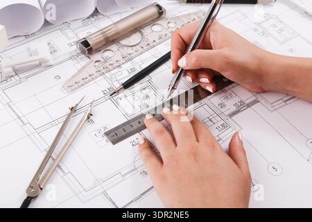 Design and Planning Process With Tools and Blueprints for a Project at a Workspace Stock Photo