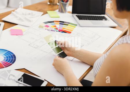 Designer Works on Color Palette Selection for Interior Project in Office Stock Photo