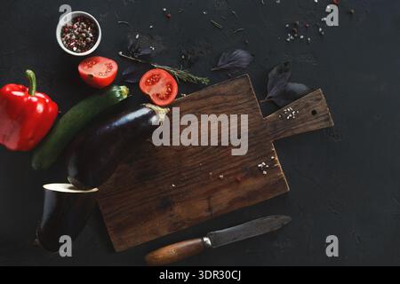 Fresh Vegetables and Herbs Are Arranged on a Cutting Board With Knife for Meal Preparation Stock Photo