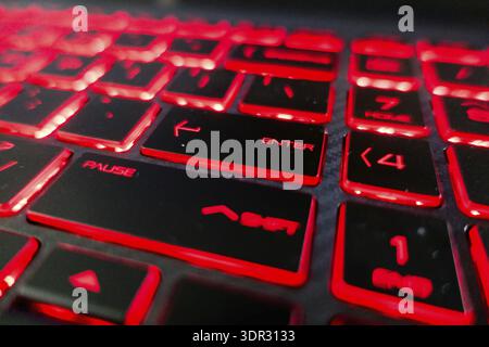 Red lights keyboard keys on black keyboard Stock Photo