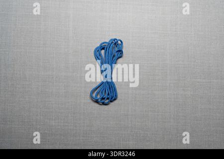 Assorted colorful cord bundles arranged in flat lay composition, craft supplies and DIY materials concept, textile accessories for macrame, sewing, de Stock Photo