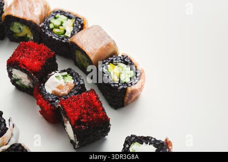 Fresh Sushi Rolls With Different Toppings Arranged on a Clean Surface Stock Photo