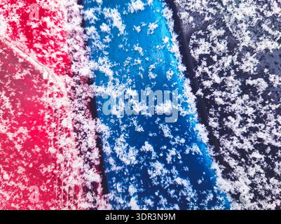 Detailed macro view of fresh snow resting on a split blue and black textured surface. Captured in Budapest, showcasing the beautiful contrast Stock Photo