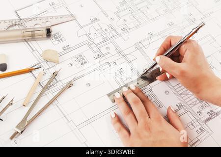 Drawing Plans on Paper With Tools for Creating a Building Design and Layout Stock Photo