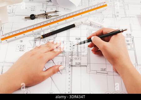 Create a Collage of Architectural Drawing Tools and Plans Displayed on a Workspace Stock Photo