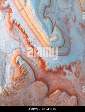 Aerial view of Earth's canvas painted with ochre and sky blue hues, sculpted by wind and time into a textured masterpiece, Kyzylkum, Mangystau Region, Stock Photo