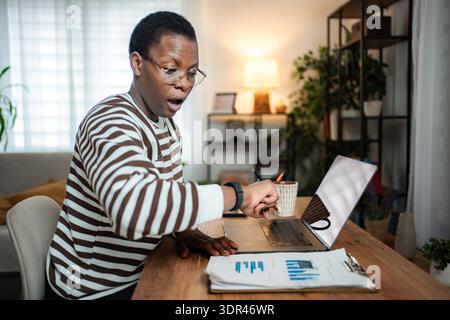 African American man feeling shock looking at smartwatch time Stock Photo