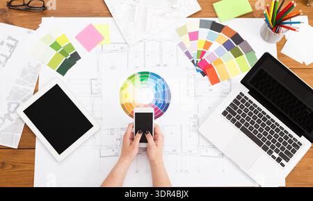 Design Planning With Color Samples and Digital Tools on a Wooden Table in a Studio Environment Stock Photo