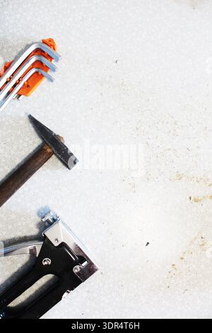 Concept background on the theme of construction and renovation. Hammer screwdriver construction stapler with space for text copyspace. Stock Photo