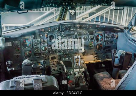 The cockpit of an airplane is shown with a view of the controls and gauges. The pilot is in the cockpit and is ready to take off Stock Photo
