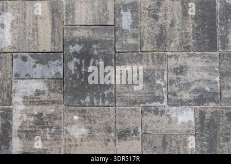 Grey stone pavement with rectangular concrete pavers forming textured urban surface pattern Stock Photo