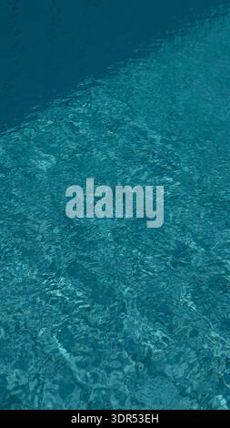 Blue mind pool water texture with sunlit ripples over tiles creating calm turquoise pattern and soothing summer serenity in clean minimal aquatic Stock Photo